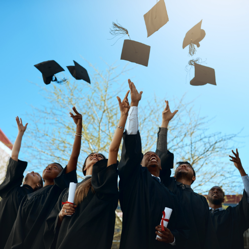 graduates throwing their caps in the air