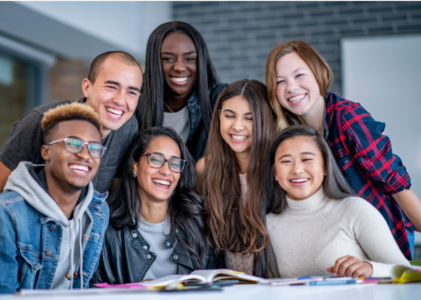 Student group smiling at a table